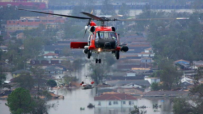 A person is lifted to safety by a Coast Guard helicopter in the aftermath of Hurricane Katrina 30 August, 2005 in New Orleans, Louisiana