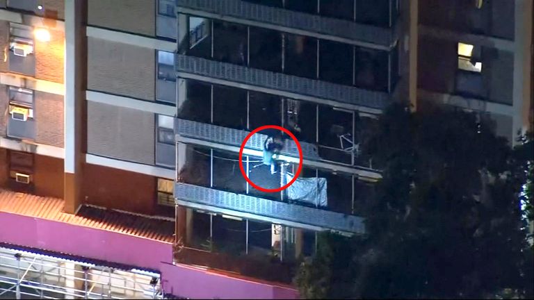 Man scales down high-rise building to escape fire