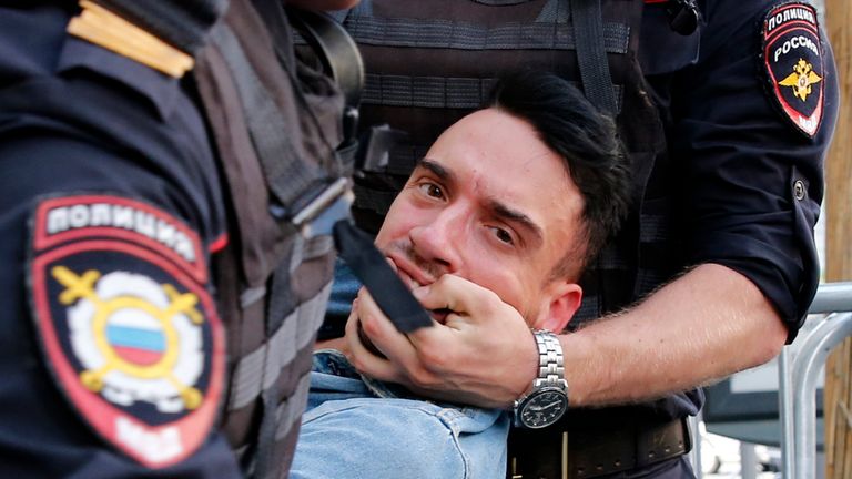 Police officers detain a protester during an unauthorised rally demanding independent and opposition candidates be allowed to run for office in local election in September, in downtown Moscow on July 27, 2019. (Photo by Maxim ZMEYEV / AFP) (Photo credit should read MAXIM ZMEYEV/AFP/Getty Images)
