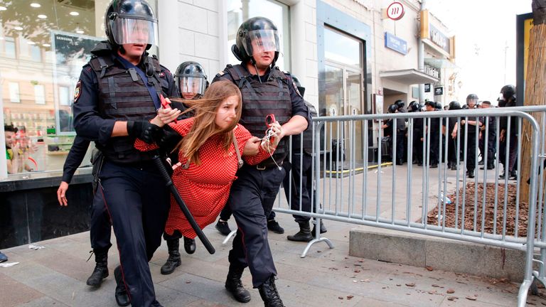 Police officers detain a protester during an unauthorised rally demanding independent and opposition candidates be allowed to run for office in local election in September, in downtown Moscow on July 27, 2019. (Photo by Maxim ZMEYEV / AFP) (Photo credit should read MAXIM ZMEYEV/AFP/Getty Images)
