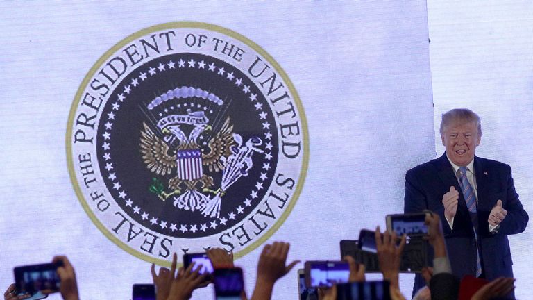 The president seemed oblivious to the hoax seal behind him