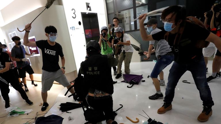 Protesters have clashed with riot police in a mainland shopping centre