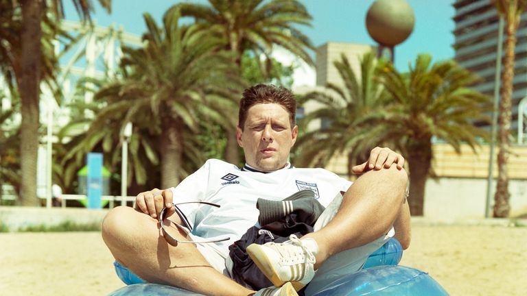 Shaun Ryder of Black Grape and The Happy Mondays sitting on an inflatable chair on a beach, USA, 1999