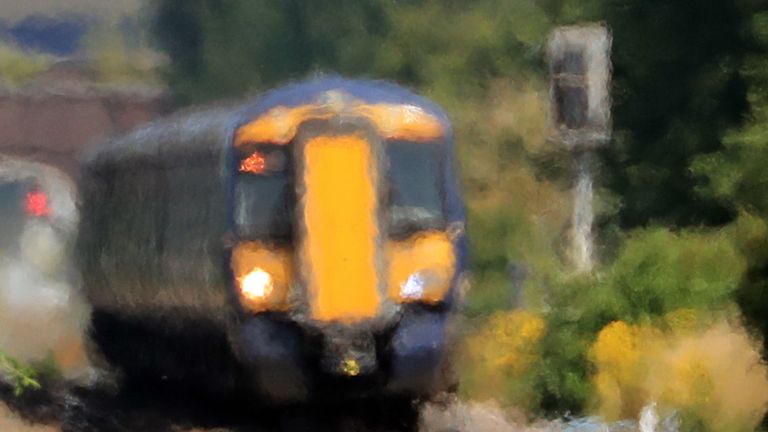 A Southeastern train passes through heat haze in Ashford, Kent