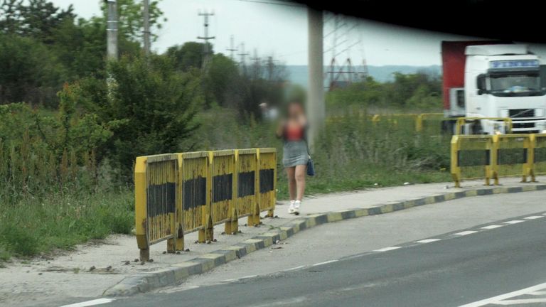 Generic shot of a young female sex worker next to the road in Craiova (note: faces intentionally blurred to protect identities)