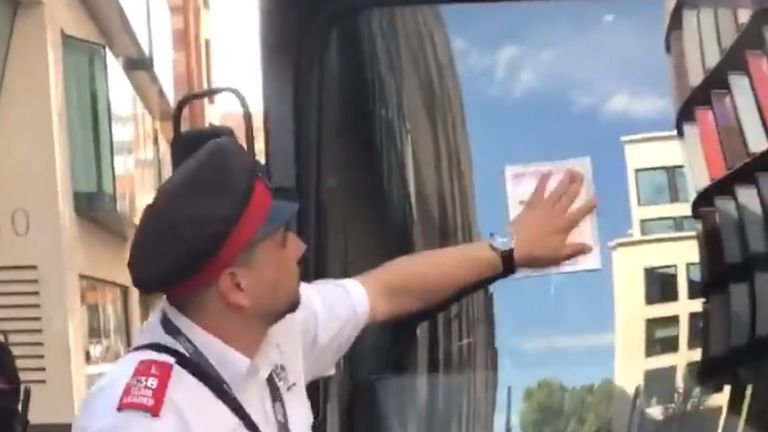 A ticket warden put a ticket on a bus belonging to supporters of  EDL founder Tommy Robinson outside the Old Bailey, London
