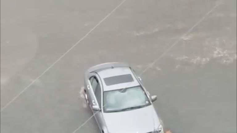 A man is helped from his stranded car