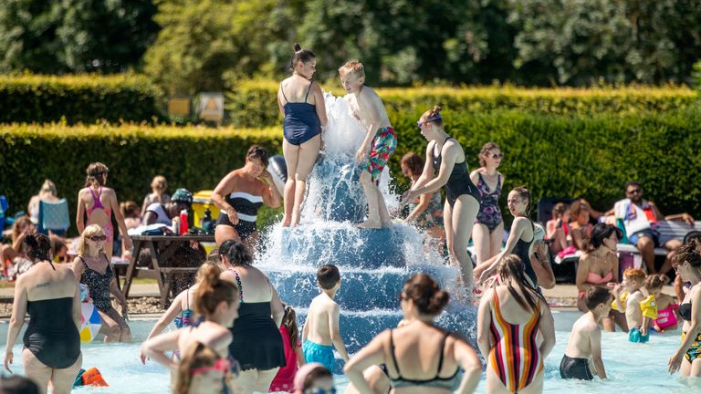 People enjoy the sun at Ilkley outdoor pool and lido in West Yorkshire 