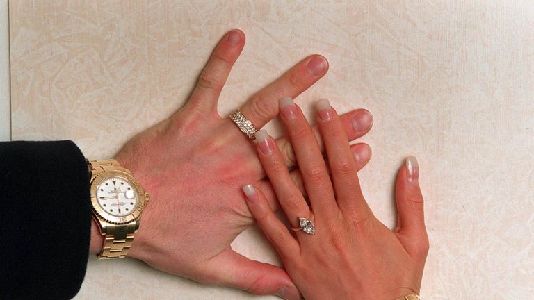 David and Victoria Beckham (then Adams) show off their engagement rings - 1998
