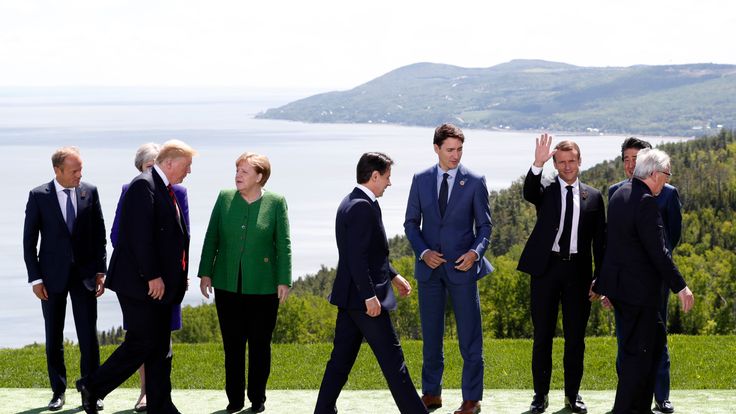 The G7 summit leaders, including European Council President Donald Tusk, Britain's Prime Minister Theresa May, Germany's Chancellor Angela Merkel, Canada's Prime Minister Justin Trudeau, U.S. President Donald Trump, France's President Emmanuel Macron, Japan's Prime Minister Shinzo Abe and European Commission President Jean-Claude Juncker after posing for a family photo with the leaders of the G-7 summit in the Charlevoix city of La Malbaie
