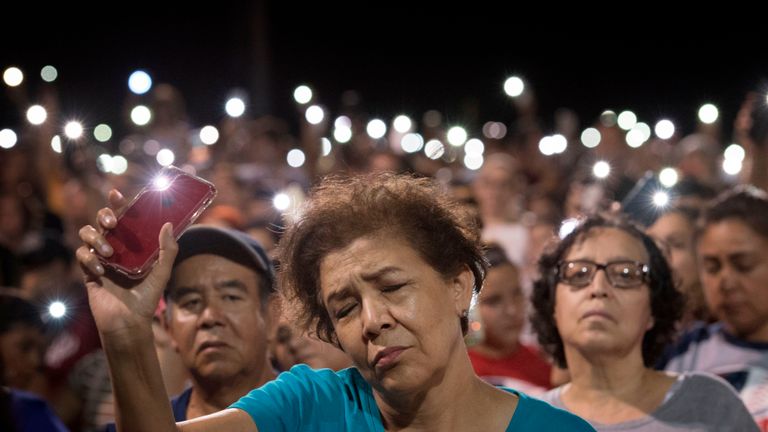 People react during a prayer vigil organized by the city, after a shooting left 20 people dead at the Cielo Vista Mall Wal-Mart in El Paso, Texas, on August 4, 2019. - The United States mourned Sunday for victims of two mass shootings that killed 29 people in less than 24 hours as debate raged over whether President Donald Trump's rhetoric was partly to blame for surging gun violence. The rampages turned innocent snippets of everyday life into nightmares of bloodshed: 20 people were shot dead while shopping at a crowded Walmart in El Paso, Texas on Saturday morning, and nine more outside a bar in a popular nightlife district in Dayton, Ohio just 13 hours later. (Photo by Mark RALSTON / AFP)        (Photo credit should read MARK RALSTON/AFP/Getty Images)