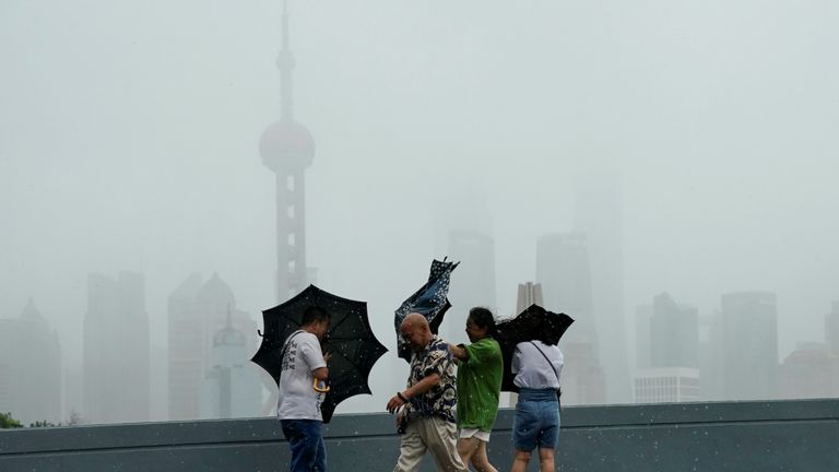 People walk in the rainstorm as typhoon Lekima approaches in Shanghai, China August 10, 2019. REUTERS/Aly Song