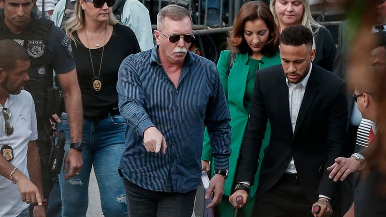 Brazilian football player Neymar (R) arrives on crutches at the Women's Defence Precinct in Sao Paulo, Brazil on June 13, 2019 to testify after Brazilian Najila Trindade filed a complaint against him on May 31, saying he assaulted her after inviting her to visit him in Paris. - Brazilian police said on Thursday they had filed a defamation suit against the woman who has accused football star Neymar of rape, after she insinuated the force was corrupt. (Photo by Ari FERREIRA / AFP)        (Photo credit should read ARI FERREIRA/AFP/Getty Images)