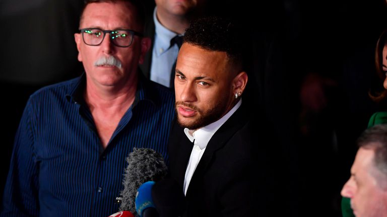 Brazilian football player Neymar (C) speaks to media members as he leaves on crutches from the Women's Defence Precinct in Sao Paulo, Brazil, on June 13, 2019, after testifying due to Brazilian Najila Trindade filed a complaint against him on May 31, saying he assaulted her after inviting her to visit him in Paris. - Brazilian police said on Thursday they had filed a defamation suit against the woman who has accused football star Neymar of rape, after she insinuated the force was corrupt. (Photo by Nelson Almeida / AFP)        (Photo credit should read NELSON ALMEIDA/AFP/Getty Images)