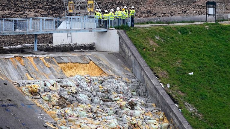WHALEY BRIDGE, ENGLAND - AUGUST 21: Work continues at the Whaley Bridge Dam site to shore up the damaged dam on August 20, 2019 in Whaley Bridge, England. Approximately 1,500 residents of the town's 6,500 population were forced to leave their homes after the partial collapse of the dam at Toddbrook Reservoir, in Derbyshire, at the beginning of August. Engineers have cleared the reservoir of water and installed pumps to keep the reservoir dry during operations. (Photo by Christopher Furlong/Getty Images)