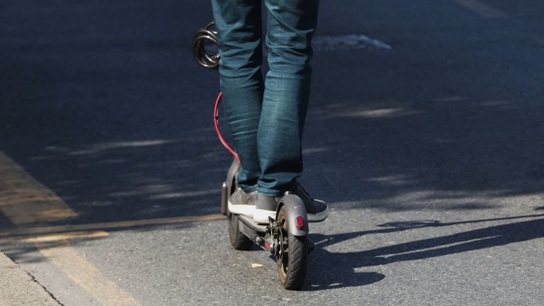 An electric scooter rider travels along Alexandra Road, Wimbledon.