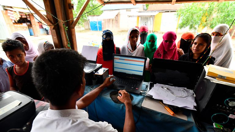 People check their names on the final list of the National Register of Citizens (NRC) at a roadside shop in Pavakati village of Morigoan district, some 70 kms from Guwahati, the capital city of India's northeastern state of Assam on August 31, 2019. - Almost two million people in northeast India were left facing statelessness on August 31 after the state of Assam published a citizenship list aimed at weeding out "foreign infiltrators", in a process the central government wants to replicate nationwide. (Photo by Biju BORO / AFP)        (Photo credit should read BIJU BORO/AFP/Getty Images)