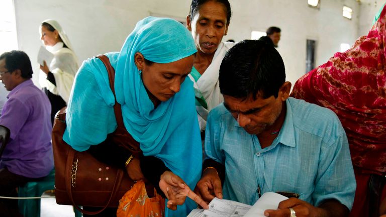 People check their names on the final list of the National Register of Citizens (NRC) at Buraburi village in Morigaon district of Assam on August 31, 2019. - Almost two million people in northeast India were left facing statelessness on August 31 after the state of Assam published a citizenship list aimed at weeding out "foreign infiltrators", in a process the central government wants to replicate nationwide. (Photo by David TALUKDAR / AFP)        (Photo credit should read DAVID TALUKDAR/AFP/Getty Images)
