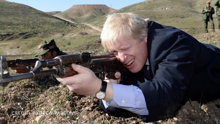 Mr Johnson poses with a gun. Pic: Andrew Parsons