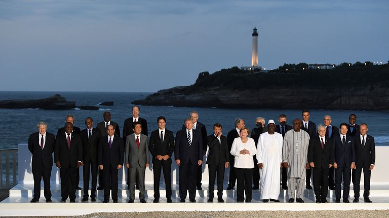 French President Emmanuel Macron, U.S. President Donald Trump, Japan&#39;s Prime Minister Shinzo Abe, Britain&#39;s Prime Minister Boris Johnson, German Chancellor Angela Merkel, Canada&#39;s Prime Minister Justin Trudeau and Italy&#39;s acting Prime Minister Giuseppe Conte pose for a family photo with invited guests during the G7 summit in Biarritz, France, August 25, 2019