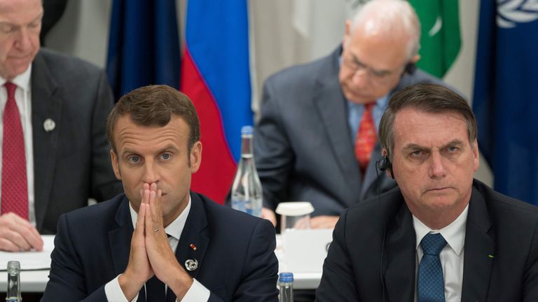 France&#39;s President Emmanuel Macron (L) and Brazil&#39;s President Jair Bolsonaro attend a meeting on the digital economy at the G20 Summit in Osaka on June 28, 2019. (Photo by Jacques Witt / POOL / AFP) (Photo credit should read JACQUES WITT/AFP/Getty Images)
