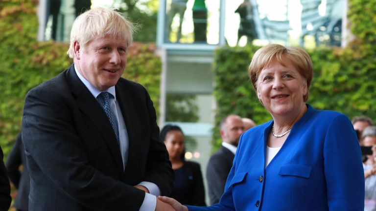 Boris Johnson is greeted by German Chancellor Angela Merkel in Berlin