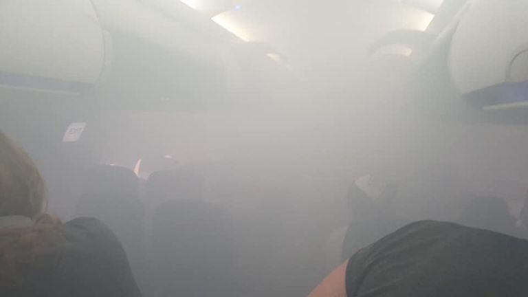 Photos have been posted by frightened passengers showing the cabin full of smoke. Pic: Twitter/@lucyaabrown 