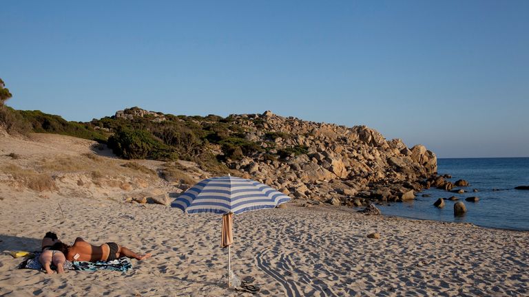 People on the beach of Chia on July 09, 2012 Province of Cagliari, Italy