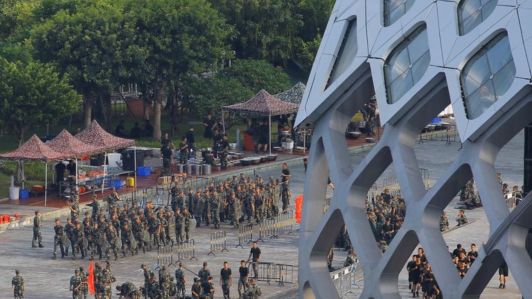 Chinese soldiers walk in formation on the grounds of the Shenzhen Bay Sports Centre in Shenzhen