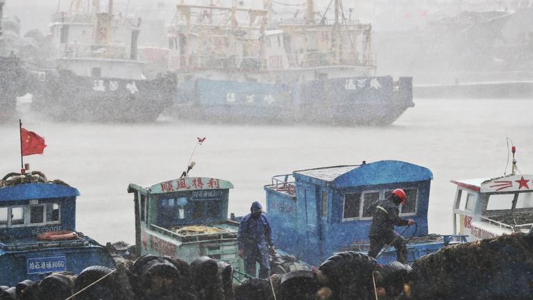 Fishermen secure boats at a port in Taizhou, China&#39;s eastern Zhejiang province, ahead of the arrival of Typhoon Lekima 