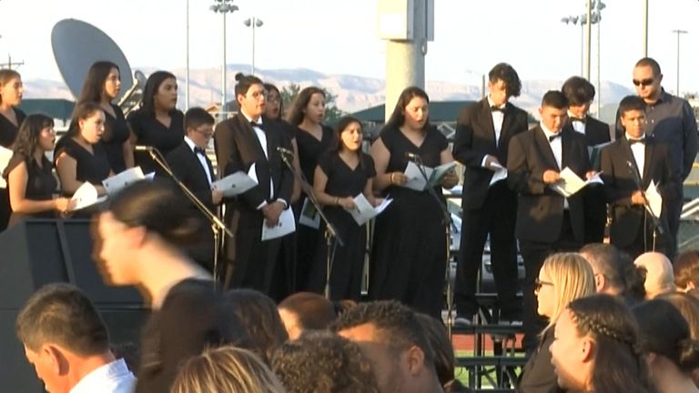 A choirs sang the national anthem and Earth Song by Frank Ticheli
