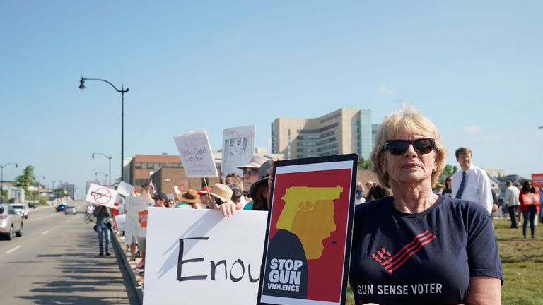 People protest against gun violence in Dayton, Ohio, as Donald Trump visits the city