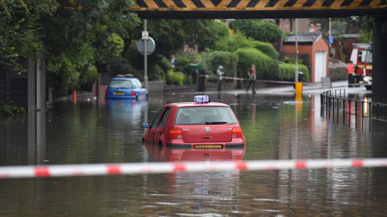 A car stranded in flood water in Crossley Road in Manchester this week