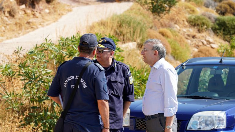 Coroner Nikos Karakoukis with police officers near the area where the body of Natalie Christopher was found 