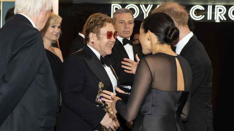 Prince Harry, Duke of Sussex and Meghan, Duchess of Sussex greet British singer-songwriter Elton John and David Furnish at the European Premiere of Disney&#39;s "The Lion King" at Odeon Luxe Leicester Square on July 14, 2019 in London, England