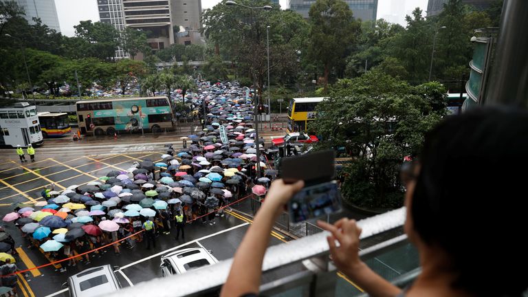 Black-clad teachers march against the use of police force on protesters