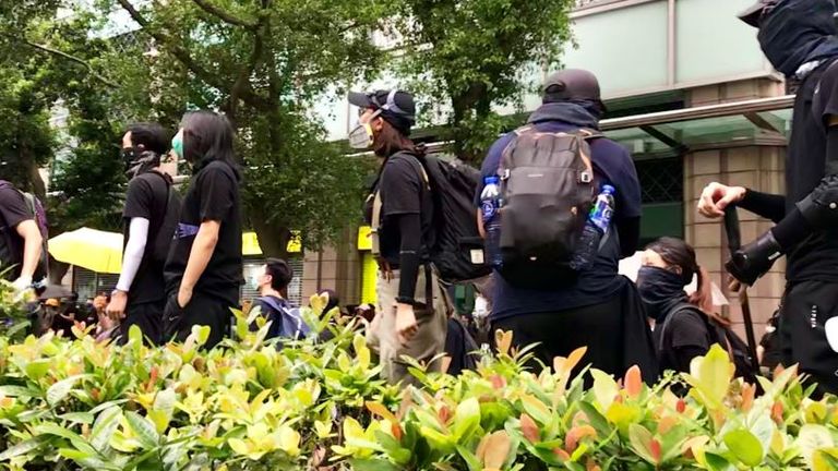 A police station is surrounded by protesters