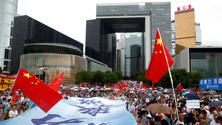 Protesters at a pro-police rally in Hong Kong raise Chinese flags