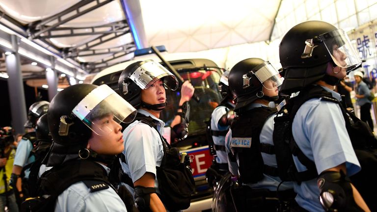 Riot officers have clashed with protesters at Hong Kong airport after flights were disrupted for a second day