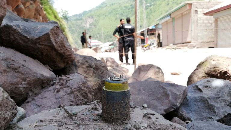 A cluster bomb shell is seen along a roadside in Noseri, near the line of control in Kashmir