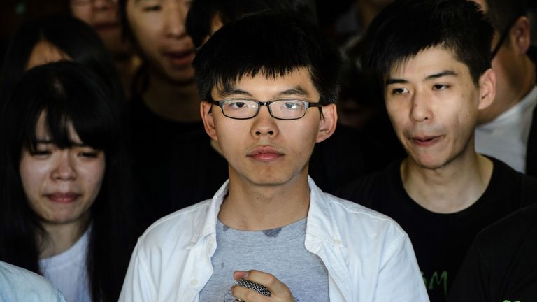 Joshua Wong (C), leader of Hong Kong&#39;s &#39;Umbrella Movement&#39;, looks on as he addresses the media before his sentencing outside the High Court in Hong Kong on August 17, 2017