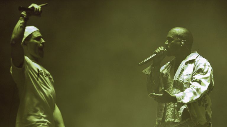 Comedian Simon Brodkin (L), playing his character Lee Nelson, interrupts singer Kanye West on the Pyramid Stage at the Glastonbury Festival at Worthy Farm near the village of Pilton in Somerset, South West England, on June 27, 2015