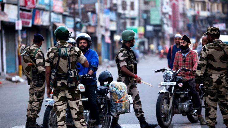 Motorists are questioned in Jammu after authorities placed large parts of the disputed region under lockdown 