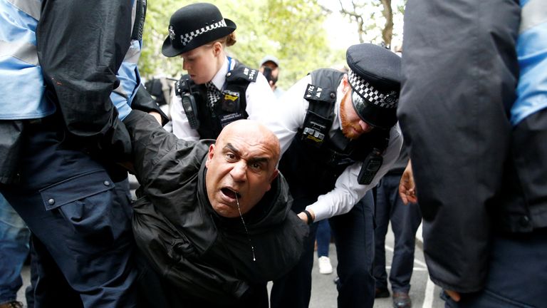Police officers detain a demonstrator during a protest against the scrapping of the special constitutional status in Kashmir by the Indian government, outside the Indian High Commission in London