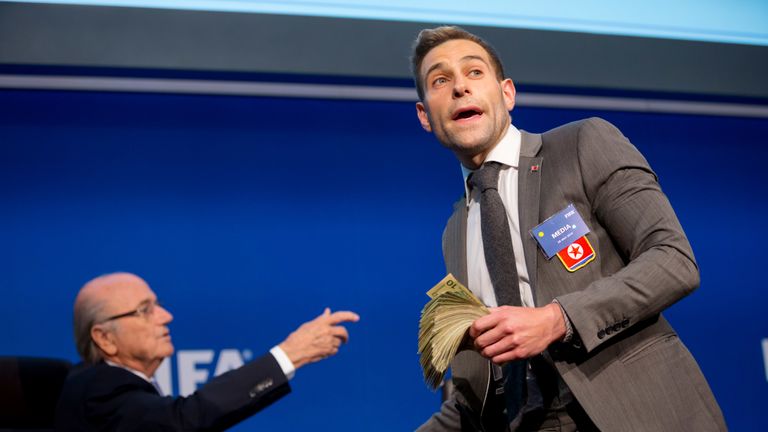 Comedian Simon Brodkin/ Lee Nelson prepares to attack FIFA President Joseph S Blatter (R) with money during a press conference at the Extraordinary FIFA Executive Committee Meeting at the FIFA headquarters on July 20, 2015 in Zurich, Switzerland
