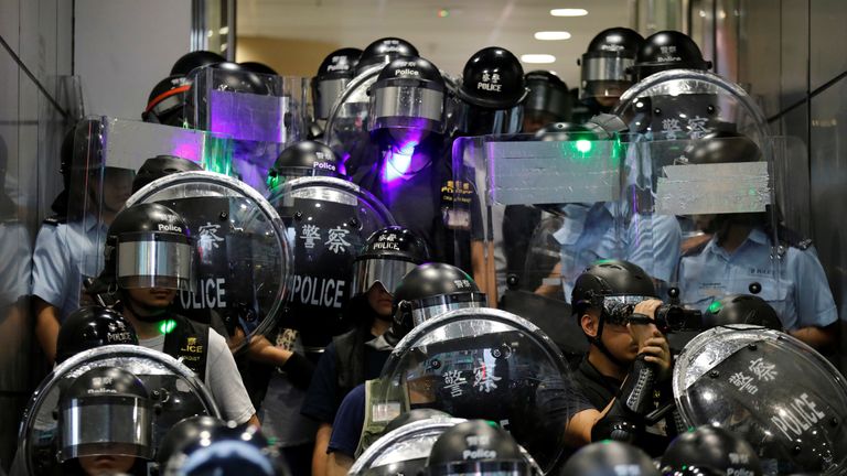 Riot police warn protesters at Mong Kok police station to clear the area