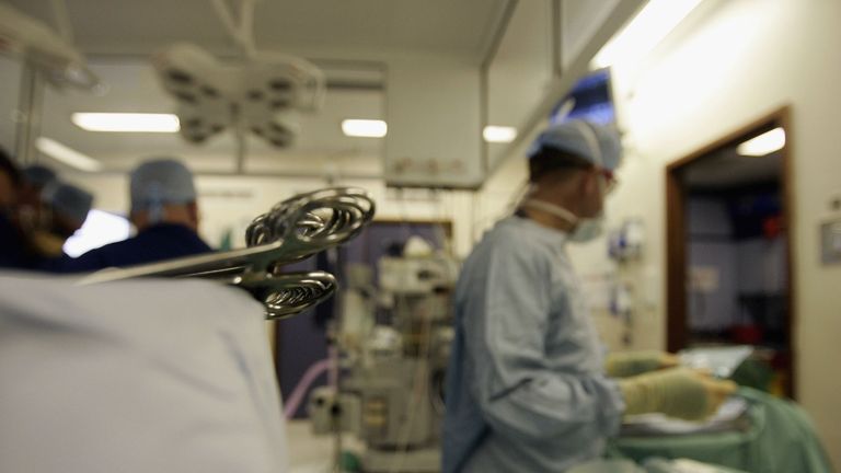 Surgeons at The Queen Elizabeth Hospital Birmingham conduct an operation 