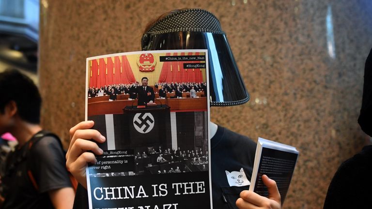 A protester holds a poster near the Causeway Bay station