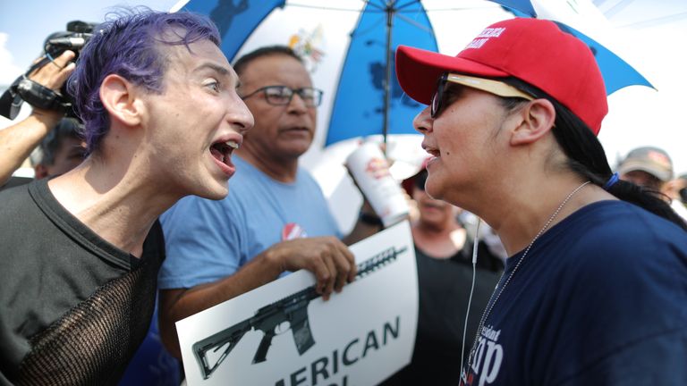 An anti-Trump protester and a Trump supporter argue outside the University Medical Center, El Paso 