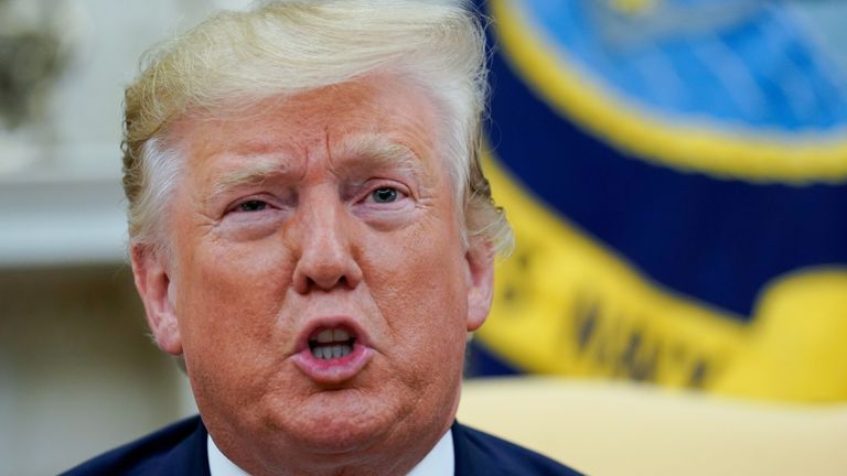 Donald Trump answers questions from reporters in the White House